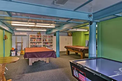 a room with a ping pong table and a pool table at Spacious Pine Mountain Club Cabin with Fire Pit in Pine Mountain Club