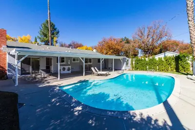 a swimming pool in front of a house at 4 Bedroom West Hills Charmer with Pool in West Hills