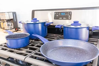 three blue pots and pans sitting on top of a stove at Newly Remodeled 2B1B House on Historic Route 66 in Glendora