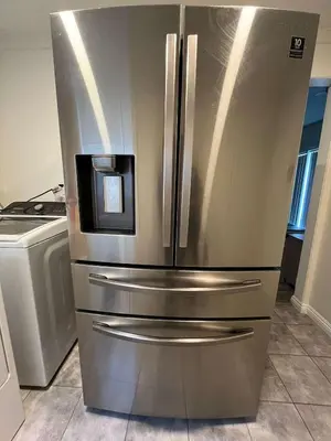 a stainless steel refrigerator in a kitchen at Newly Remodeled 2B1B House on Historic Route 66 in Glendora