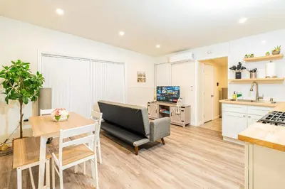 a kitchen and living room with a couch and a table at Newly Remodeled 2B1B House on Historic Route 66 in Glendora