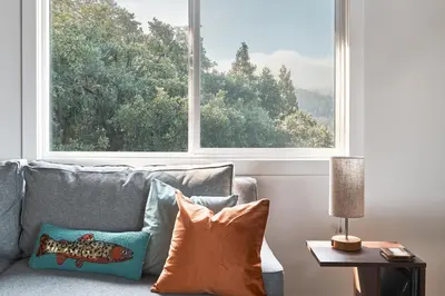 a living room with a couch and a large window at Vista Haus in Crestline
