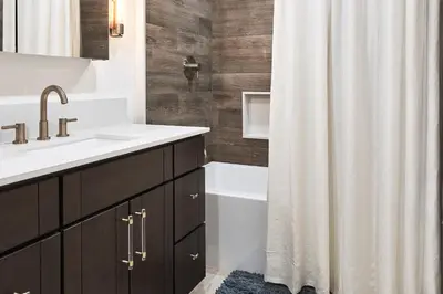 a bathroom with a sink and a shower curtain at Vista Haus in Crestline