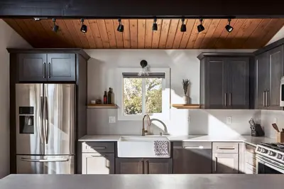 a kitchen with a stainless steel refrigerator and a sink at Vista Haus in Crestline