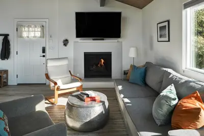 a living room with a couch and a fire place at Vista Haus in Crestline