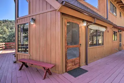 a wooden cabin with a bench on a deck at Idyllic Frazier Park Cabin Views, Pool Table in Frazier Park