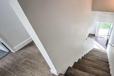 a staircase in a room with wood floors at Central Bakersfield Townhome with Private Patio in Bakersfield