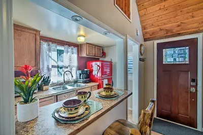 a kitchen with a counter with dishes on it at Running Springs Cabin with Deck and Forest Views in Running Springs