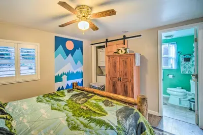 a bedroom with a bed and a ceiling fan at Running Springs Cabin with Deck and Forest Views in Running Springs