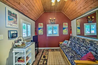 a living room with a couch and a table at Running Springs Cabin with Deck and Forest Views in Running Springs