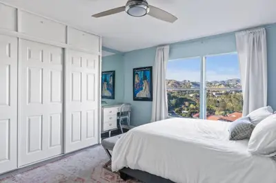 a bedroom with a bed and a large window at Hollywood Hideaway in Los Angeles