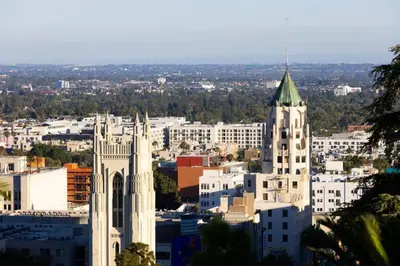 a large white building with a green steeple in a city at Hollywood Hideaway in Los Angeles