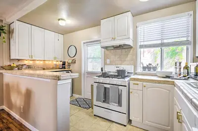 a kitchen with white cabinets and a stove top oven at 1 Mi to Dtwn Burbank Mod Gem with Private Yard in Burbank