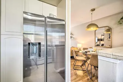 a kitchen with a refrigerator and a dining room at 1 Mi to Dtwn Burbank Mod Gem with Private Yard in Burbank