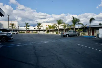 a parking lot with a truck parked in front of a building at Sands Motel by Ontario Airport & Toyota Arena in Ontario