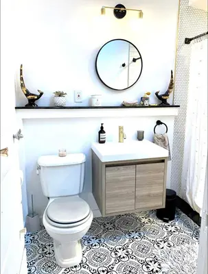 a bathroom with a toilet and a sink and a mirror at Romantic cottage with amazing garden in Glendale