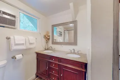 a bathroom with two sinks and a mirror at The Retreat on Wabash Lane in Lake Arrowhead