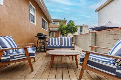 a patio with two chairs and a table on a deck at Spacious Two Bedroom in Santa Monica #E in Los Angeles