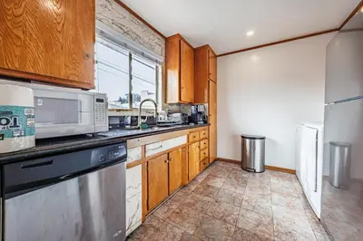 a kitchen with wooden cabinets and a microwave at Spacious Two Bedroom in Santa Monica #E in Los Angeles