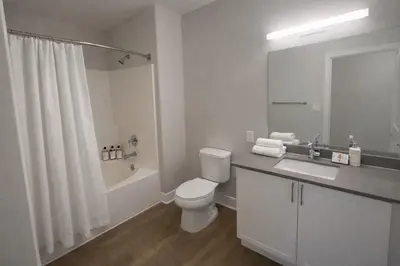 a bathroom with a toilet and a sink and a shower at Luxury 2 Bedrooms 2 Bathrooms With Pool and Gym in Los Angeles