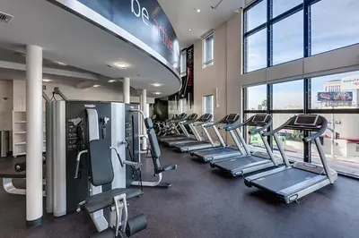 a gym with a row of treadmills and machines at Luxury 2 Bedrooms 2 Bathrooms With Pool and Gym in Los Angeles