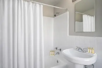a white bathroom with a sink and a shower curtain at Luxury 2 Bedroom 2 Bathroom Residence Great View in Los Angeles
