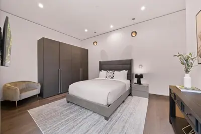 a bedroom with a bed and a chair and a dresser at Chantilly Lace in Los Angeles