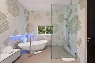 a bathroom with a tub and a glass shower at Chantilly Lace in Los Angeles