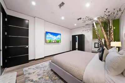 a bedroom with a large bed and a painting on the wall at Chantilly Lace in Los Angeles