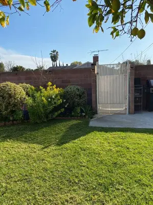 a backyard with a fence and a gate and a yard at Luxury Oasis Home w/Pool Near CSUN-6 Guests in North Hills