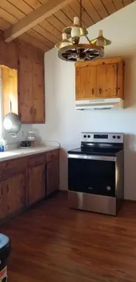 a kitchen with a stove and a ceiling at Panoramic Lake View, Lake Isabella in Wofford Heights