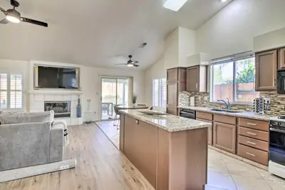 a kitchen with wooden cabinets and a counter top at Family-Friendly Getaway Community Amenities! in Bakersfield