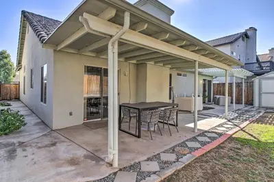 a patio with a black table and chairs at Family-Friendly Getaway Community Amenities! in Bakersfield