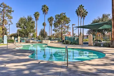 a swimming pool in a park with palm trees at Family-Friendly Getaway Community Amenities! in Bakersfield