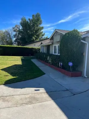 a house with a sign in front of a yard at Vacation Rental w Pool &Garden 6 Guests near CSUN in North Hills