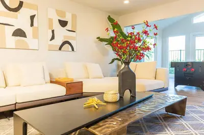a living room with a vase with flowers on a table at Single Level House with view and pool in Glendora