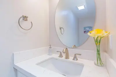 a bathroom with a white sink and a mirror at Single Level House with view and pool in Glendora