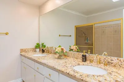 a bathroom with two sinks and a large mirror at Single Level House with view and pool in Glendora