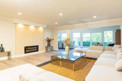 a living room with white furniture and a fireplace at Single Level House with view and pool in Glendora