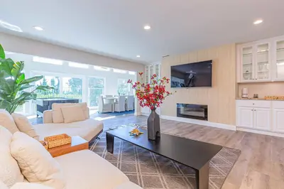 a living room with a vase of flowers on a table at Single Level House with view and pool in Glendora