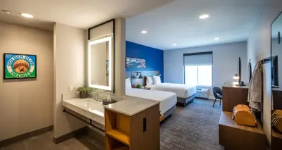 a hotel room with a bed and a bathroom at Ayres Hotel Rialto Fontana in Rialto