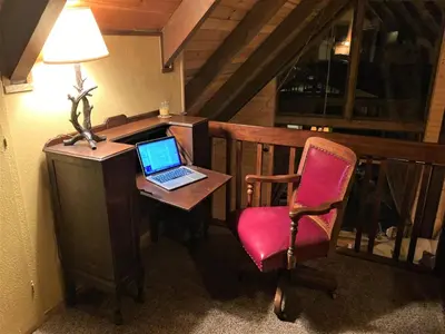 a desk with a laptop and a chair in a room at Cozy Sequoia Forest Cabin near Lake Isabella in Wofford Heights