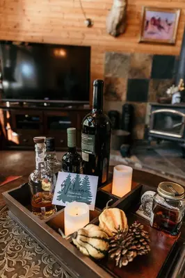 a tray with a bottle of wine and candles on a table at Cozy Sequoia Forest Cabin near Lake Isabella in Wofford Heights