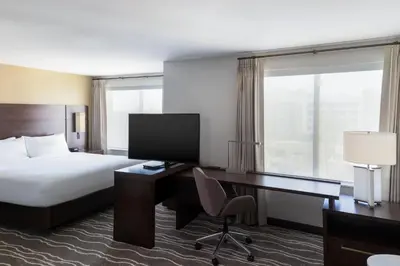 a hotel room with a bed and a desk and a computer at Residence Inn by Marriott Anaheim Brea in Brea