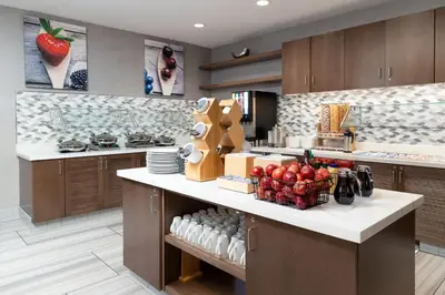 a kitchen with a counter with fruits and vegetables on it at Residence Inn by Marriott Anaheim Brea in Brea