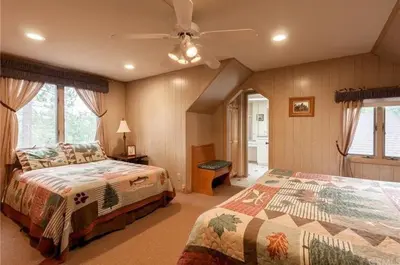 a bedroom with two beds and a ceiling fan at Narrow Escape - Close to Lake and Slopes in Big Bear Lake