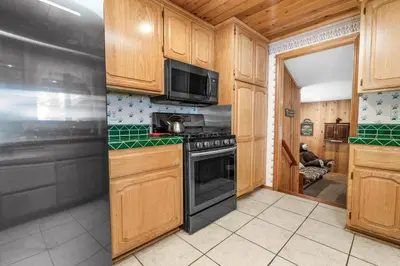 a kitchen with wooden cabinets and a stove top oven at Narrow Escape - Close to Lake and Slopes in Big Bear Lake