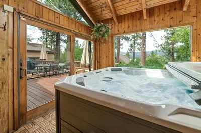 a jacuzzi tub in a house with a patio at Narrow Escape - Close to Lake and Slopes in Big Bear Lake