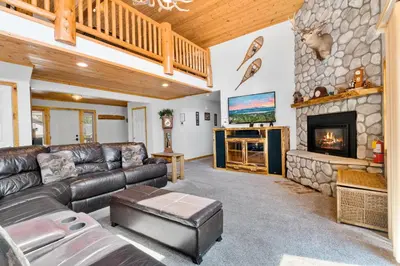 a living room with a couch and a fireplace at A Snowmass Haven - EV, Sauna, Hot Tub - Walk to Slopes/lake in Big Bear Lake