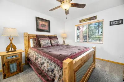 a bedroom with a bed and a ceiling fan at A Snowmass Haven - EV, Sauna, Hot Tub - Walk to Slopes/lake in Big Bear Lake